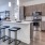 a kitchen with a bar stool and a table
