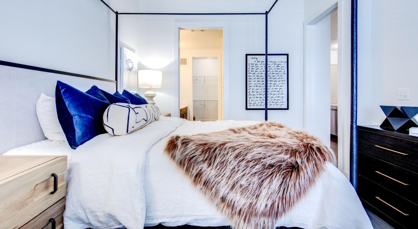 Generous bedroom offerings to fit every family a bedroom with a bed and a mirror