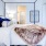 a bedroom with a bed and a mirror